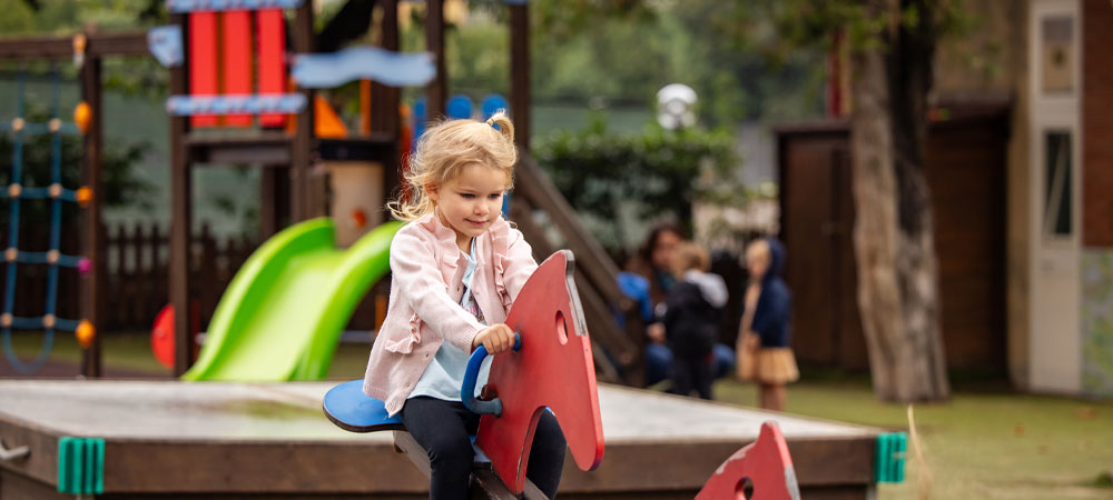 Our outdoor play areas feature age-appropriate equipment to promote physical activity and teamwork.
